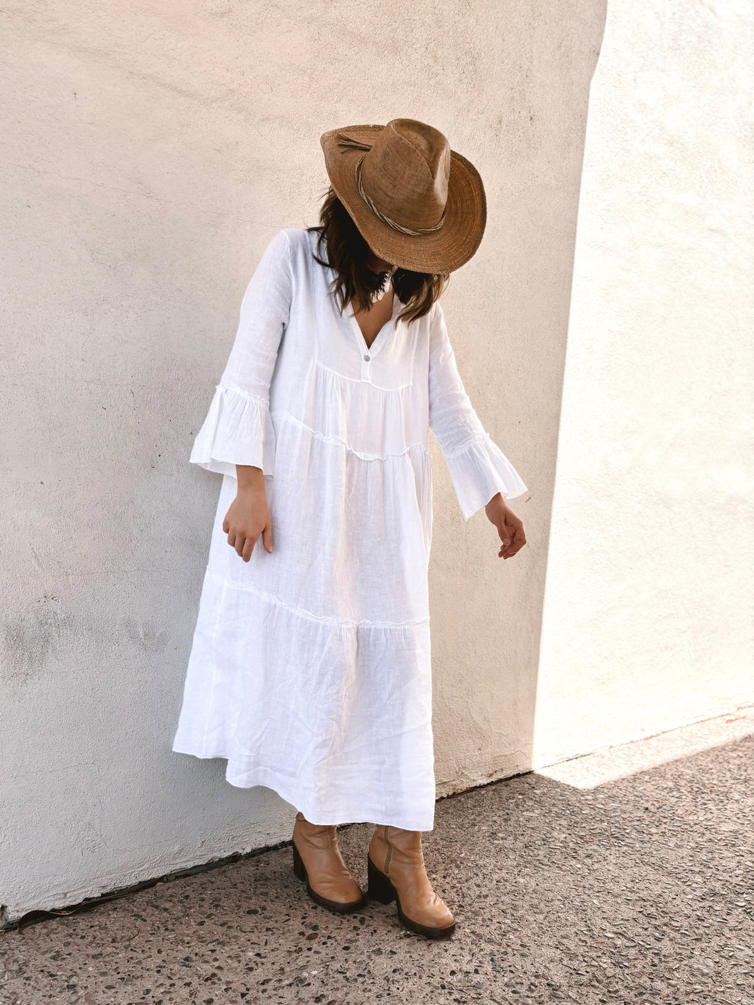 Conscious Coterie Adele Dress in White on model looking down front view