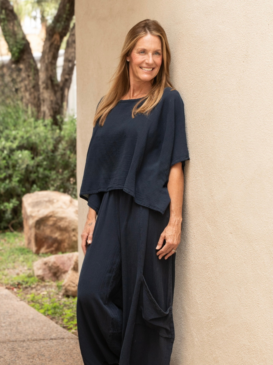 Conscious Coterie Carly top in navy blue model facing slightly forward giving more of a front view of the top