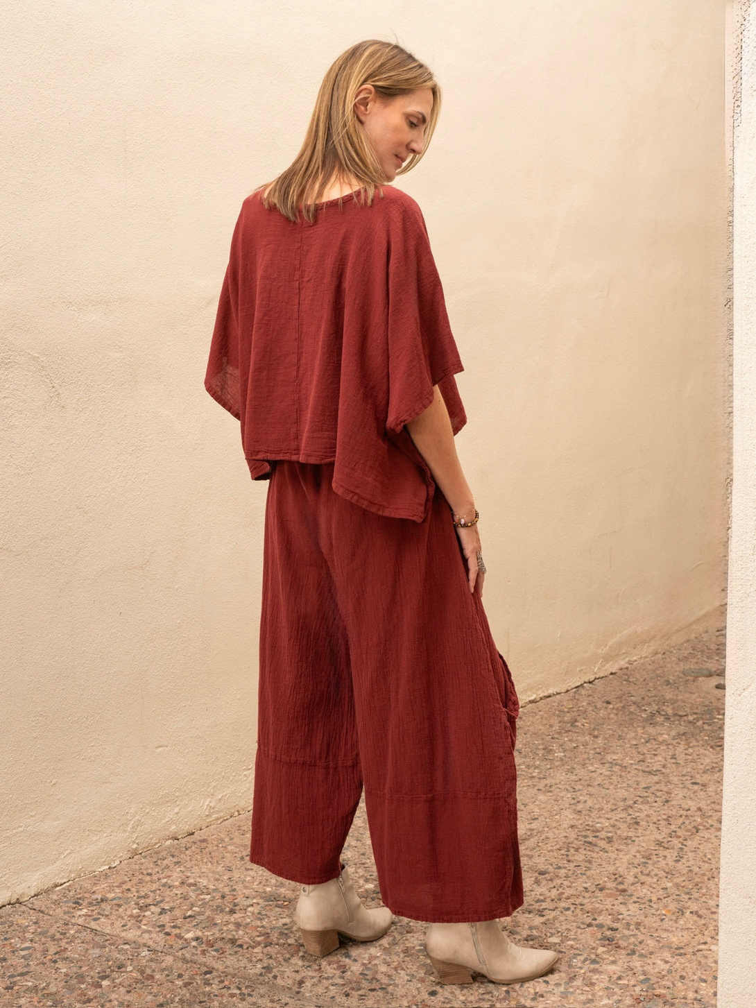 Conscious Coterie Carly cotton top in wine red woman facing away to show the back of the top 