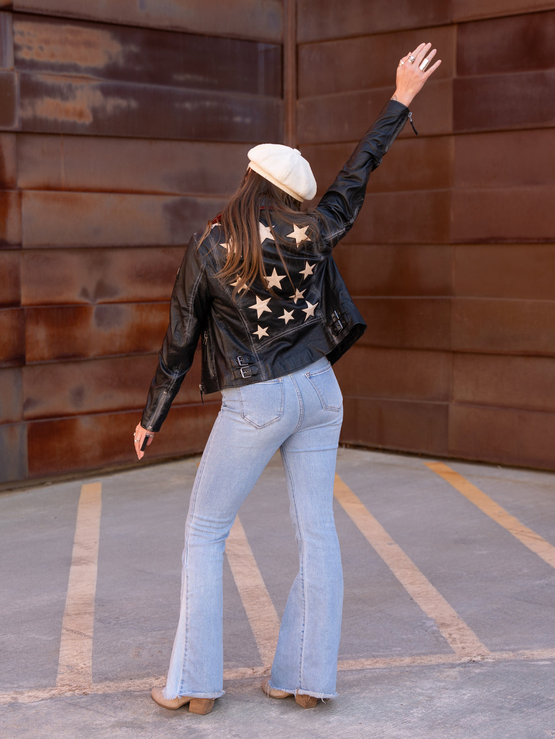 Conscious Coterie Christy Star leather jacket in vintage black on model with arm up full back view