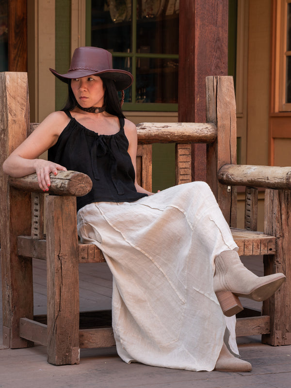 Conscious Coterie Dana Skirt in Beige on model sitting on a wooden chair