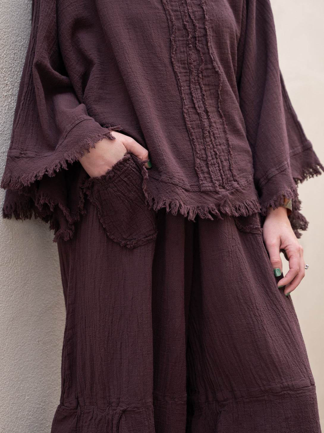 Conscious Coterie Dolly Pant in eggplant cotton on model with hand in pocket front detail view