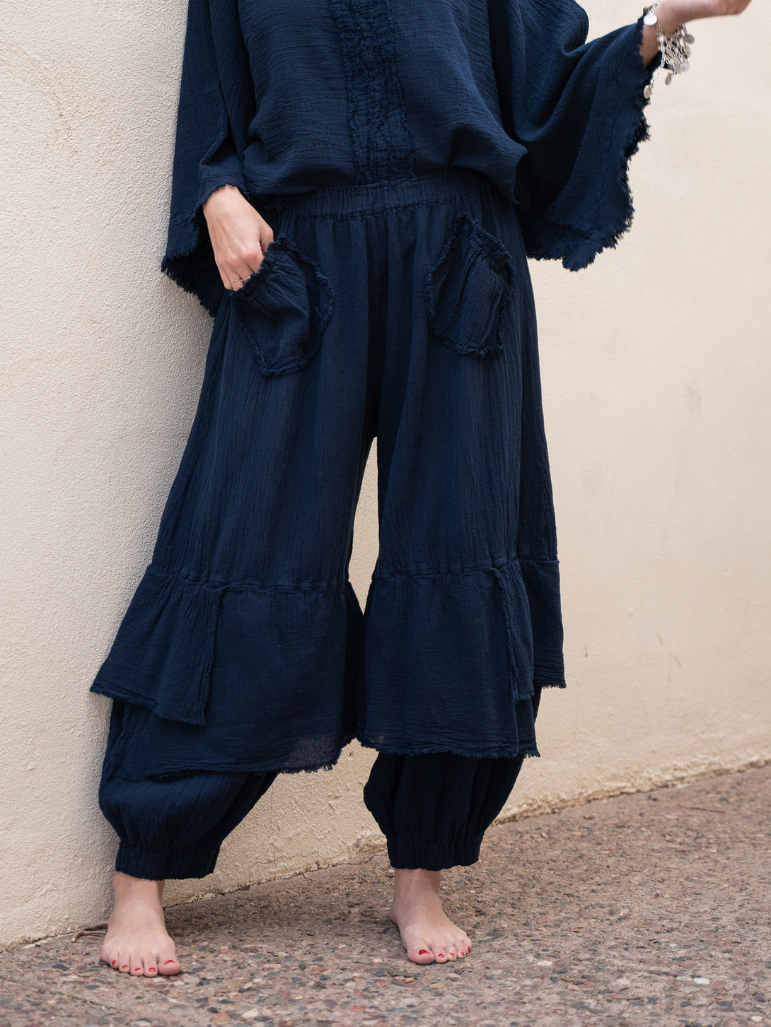 Conscious Coterie Dolly Pant in navy cotton on model with hand in pocket front view