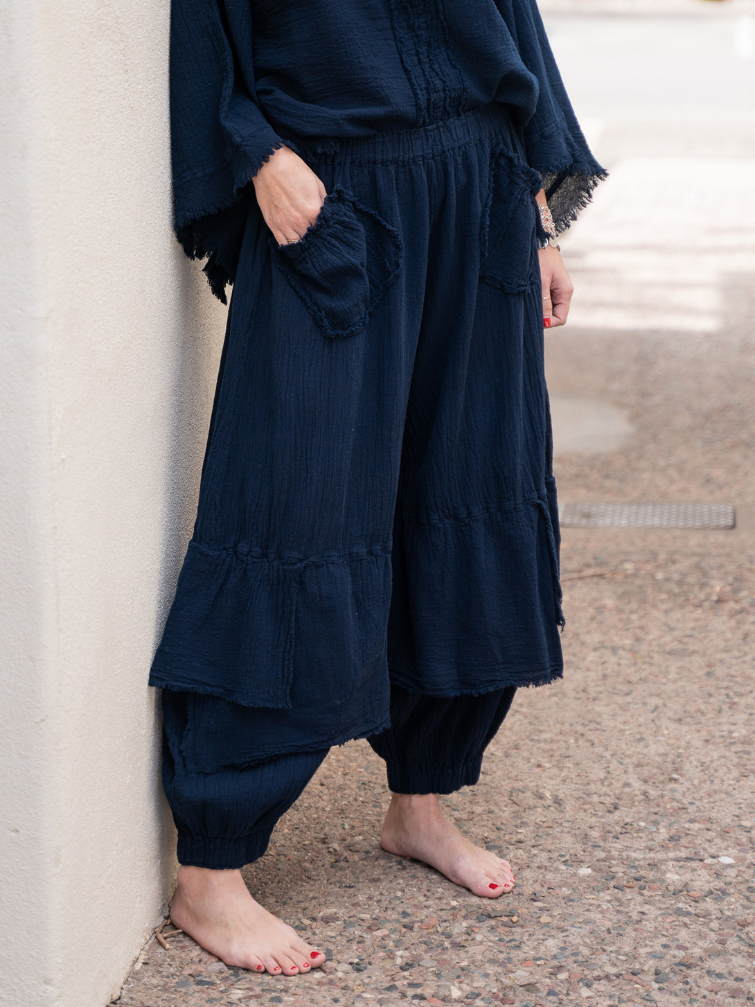 Conscious Coterie Dolly Pant in navy cotton on model with hand in pocket side view