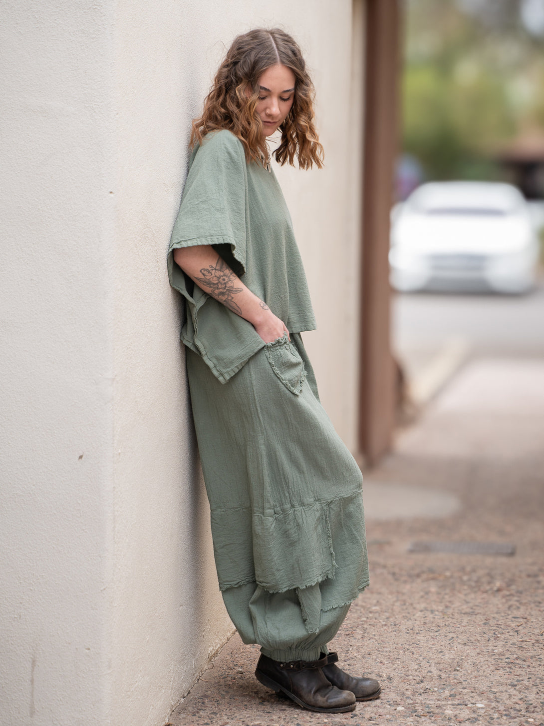 Conscious Coterie Dolly Pant in sage cotton on model looking down full side view