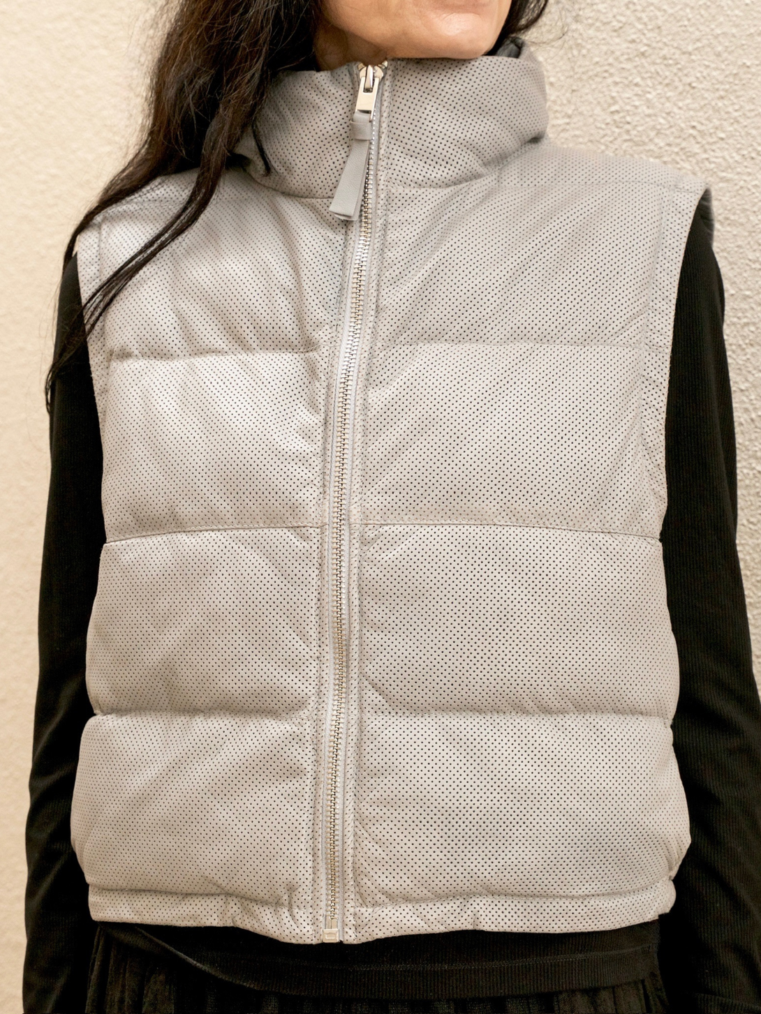 Conscious Coterie Ellice leather vest in light blue close up view of puffer vest fully zipped up on model