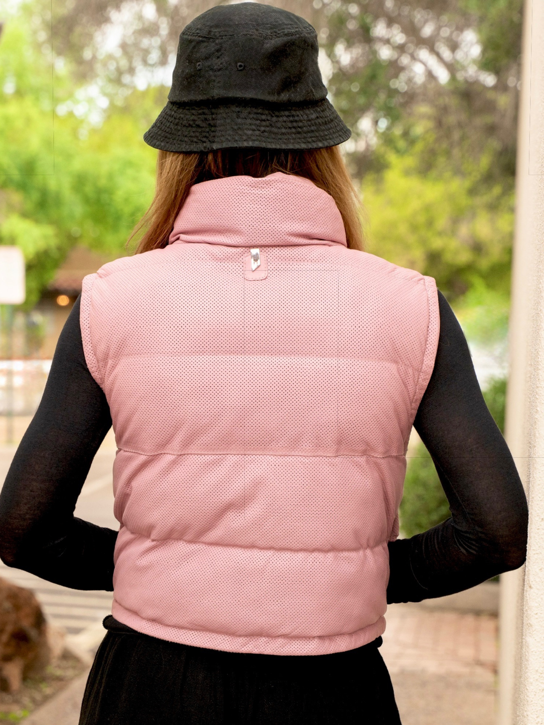 Conscious Coterie Ellice leather vest in light pink close up of the back of the puffer vest on the model