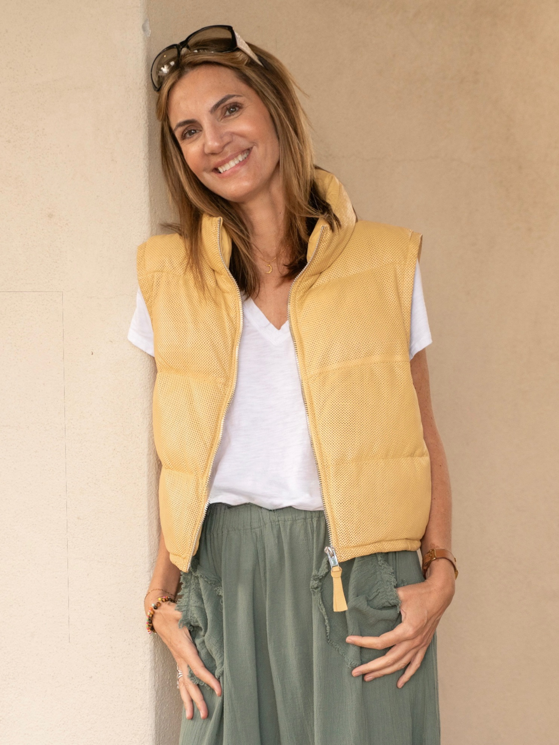 Conscious Coterie Ellice leather vest in light yellow close up view of model front facing