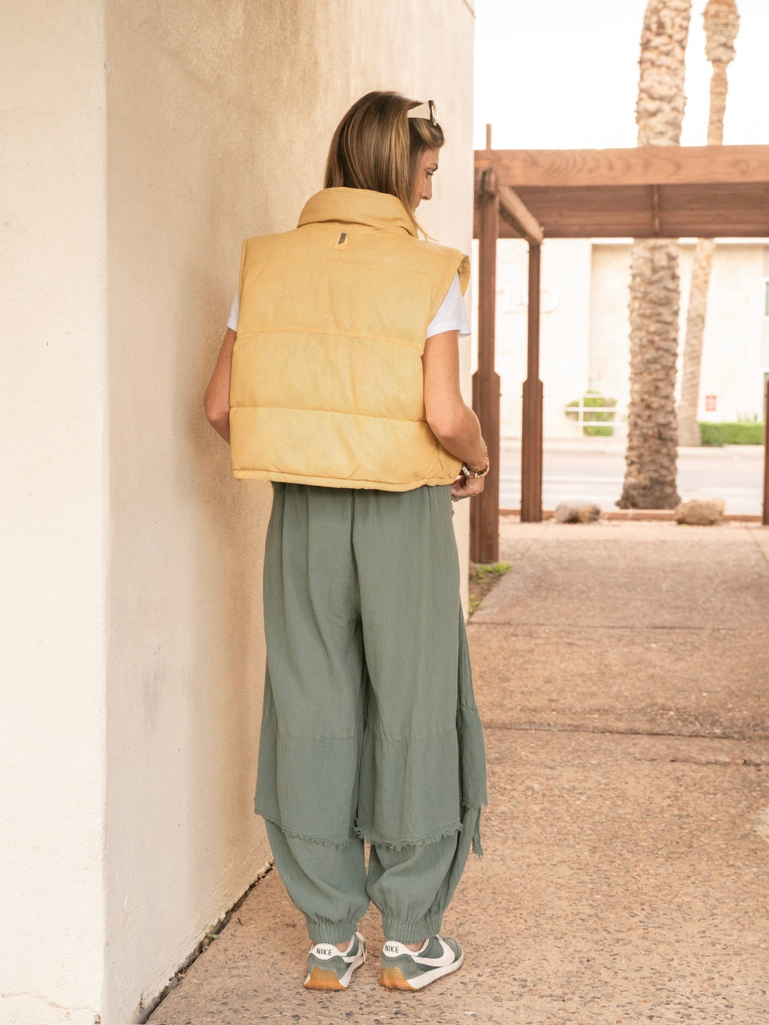 Conscious Coterie Ellice leather vest in light yellow full body view on model of the back of the vest