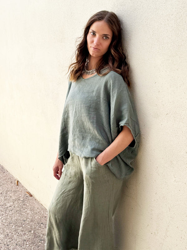 Conscious Coterie Felice Top in Olive on model with hand in pocket front view