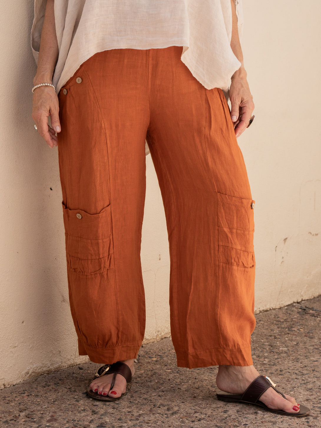 Conscious Coterie Holly Linen Pant in rust on model front view