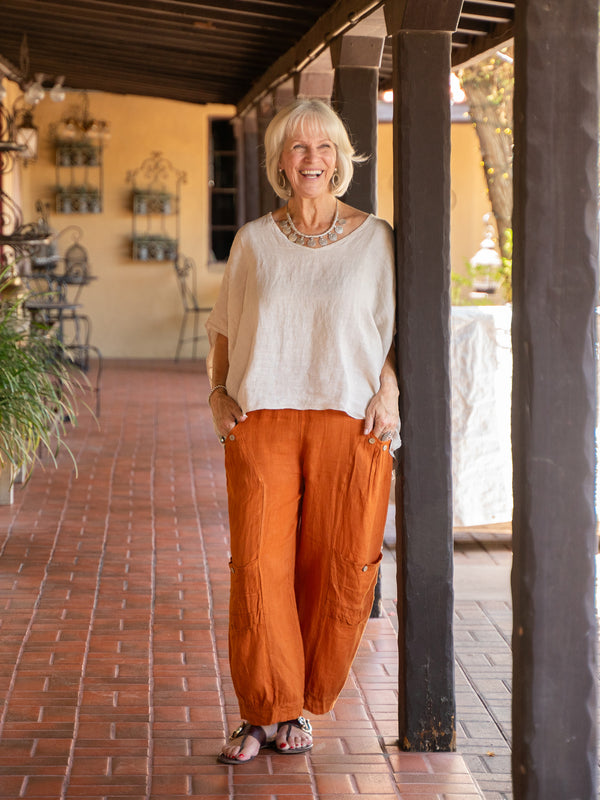 Conscious Coterie Holly Linen Pant in rust on model laughing lifestyle image