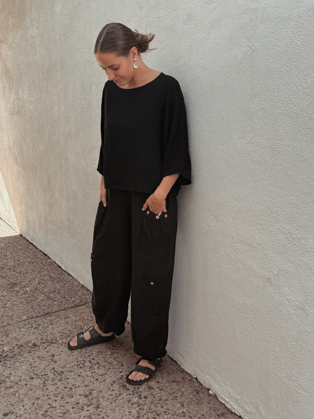 Conscious Coterie Holly Pant in Black on model looking down full front side view