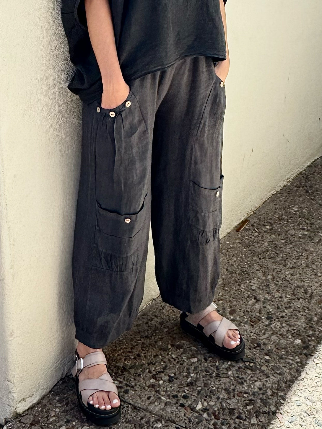 Conscious Coterie Holly Pant in Charcoal on model side bottom detail view