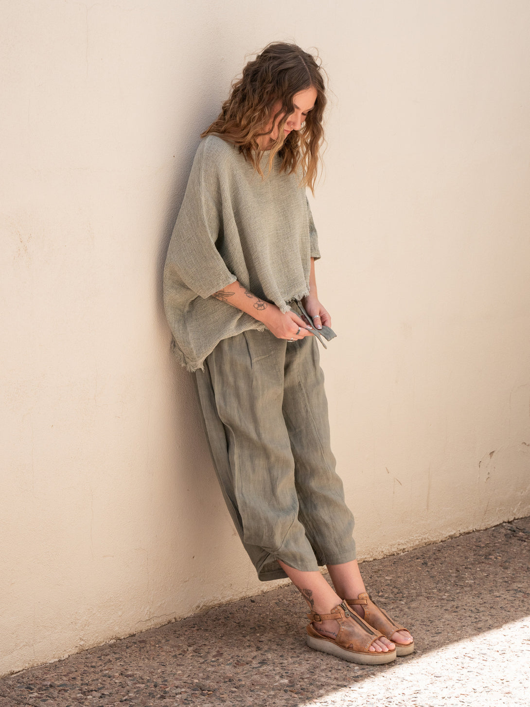 Conscious Coterie Izzy Linen Pant in olive on model looking down full side view