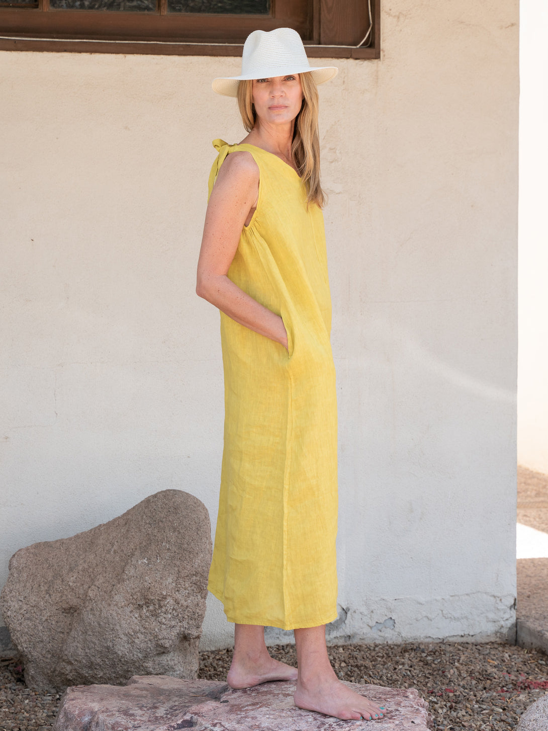 Conscious Coterie Jill Linen Dress in Mustard on model looking over shoulder full side view