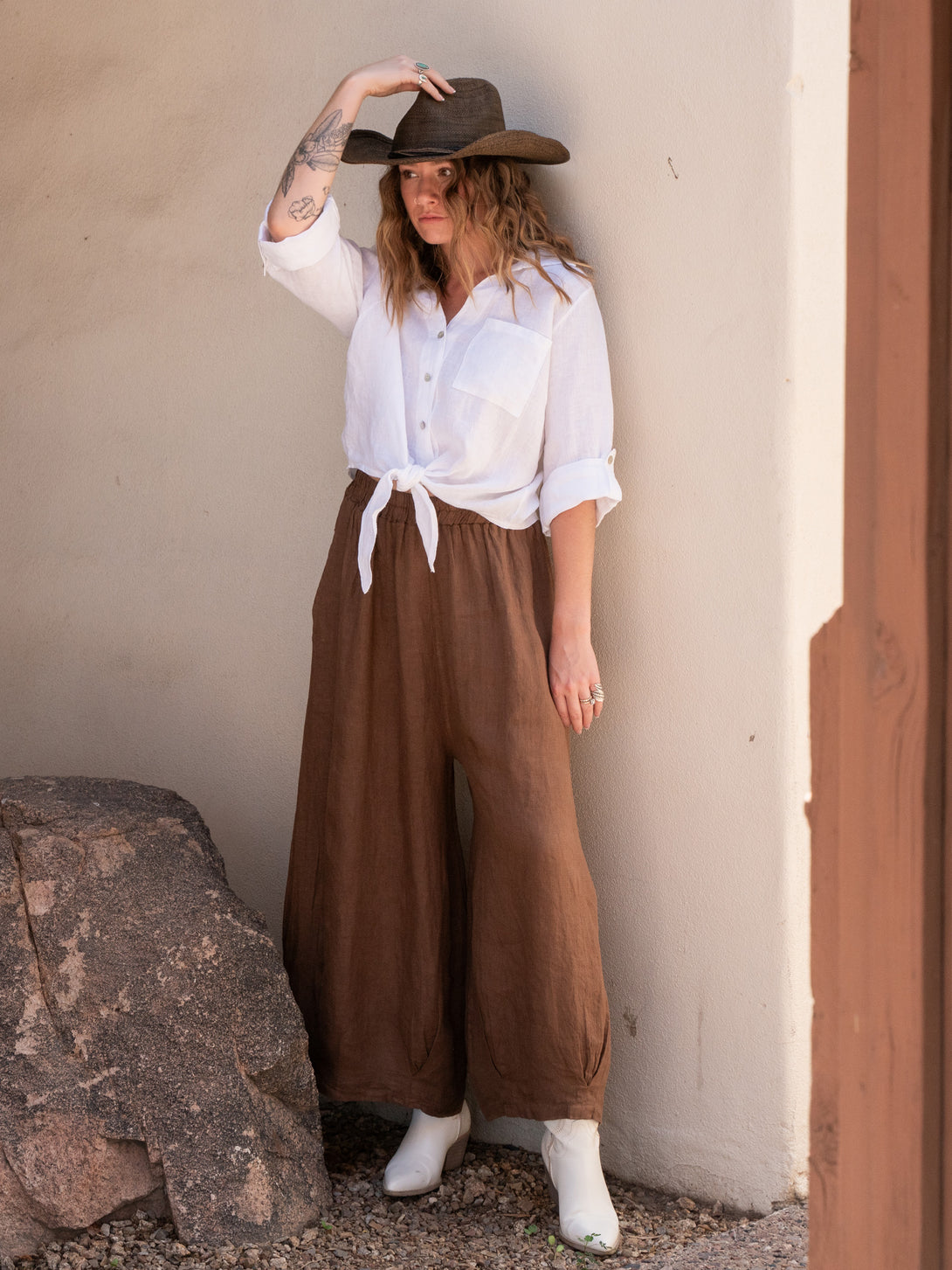 Conscious Coterie Jodi Linen Top in White on model wearing cowboy hat full front view