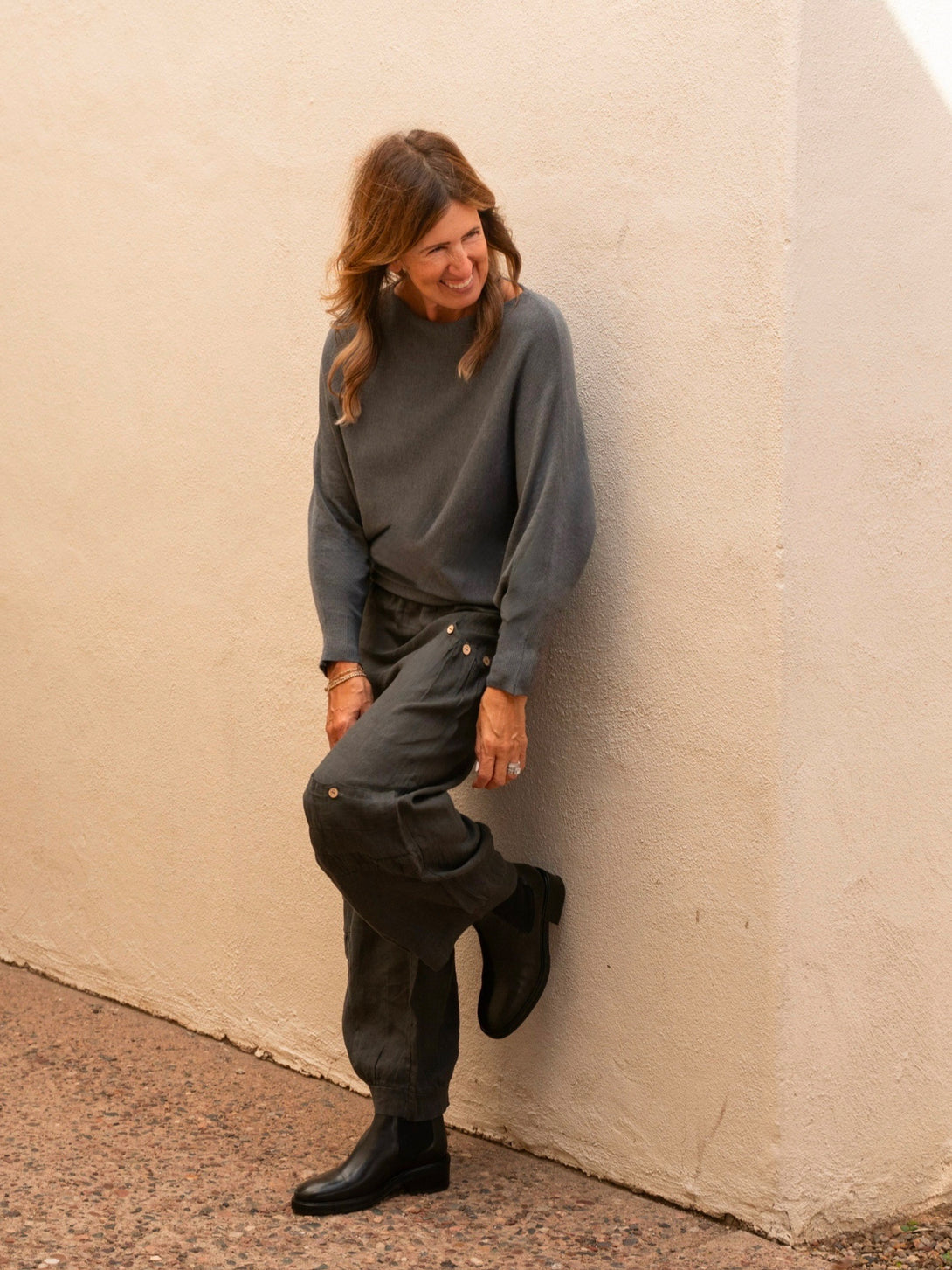 Conscious Coterie Kayla Long Sleeve Sweater in charcoal on model laughing front view