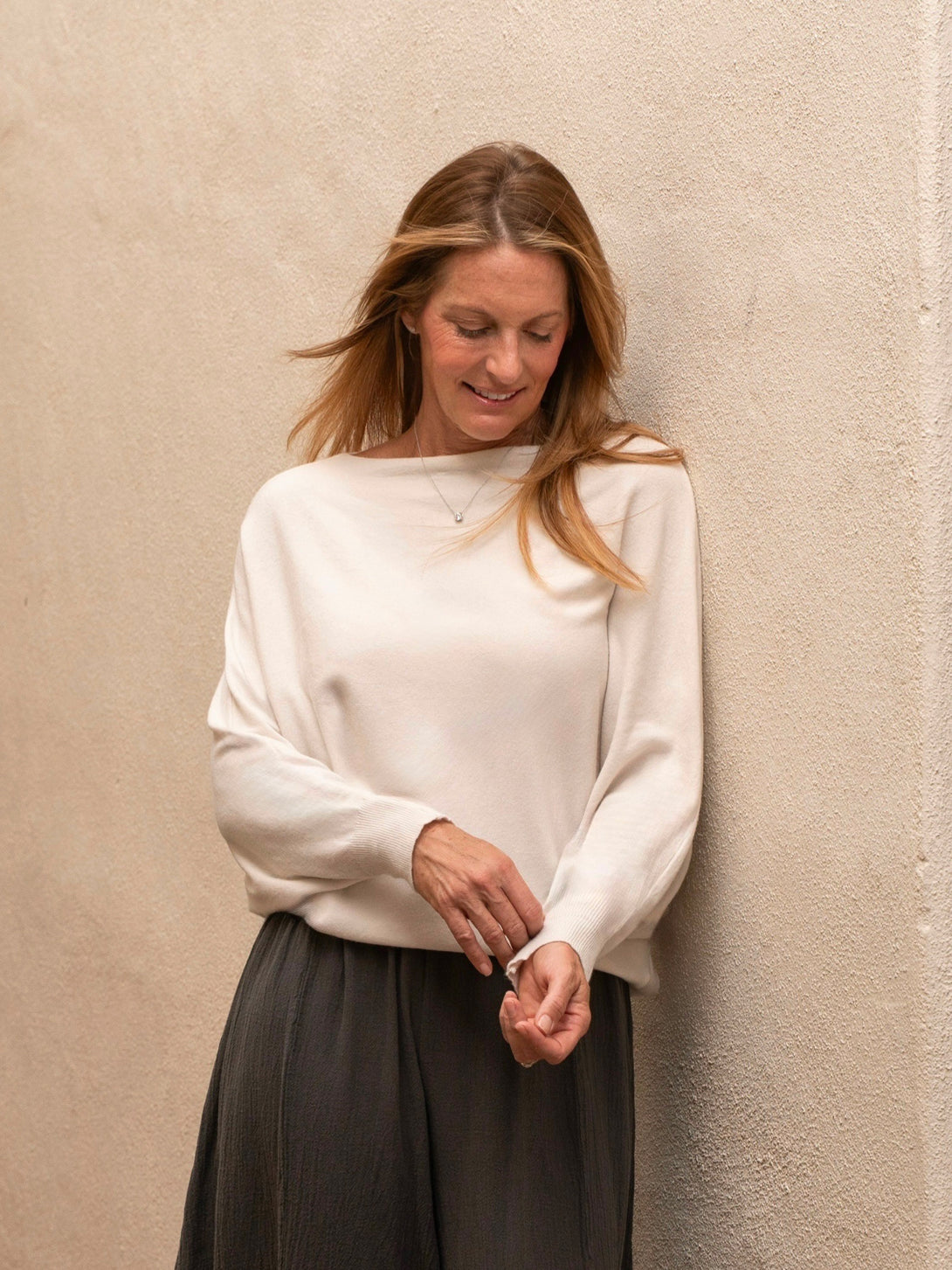 Conscious Coterie Kayla Long Sleeve Sweater in light beige on model looking down front view