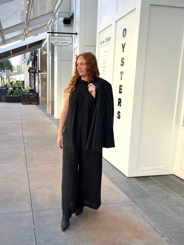 Conscious Coterie Kristen Jumpsuit in black woman walking while wearing jumpsuit