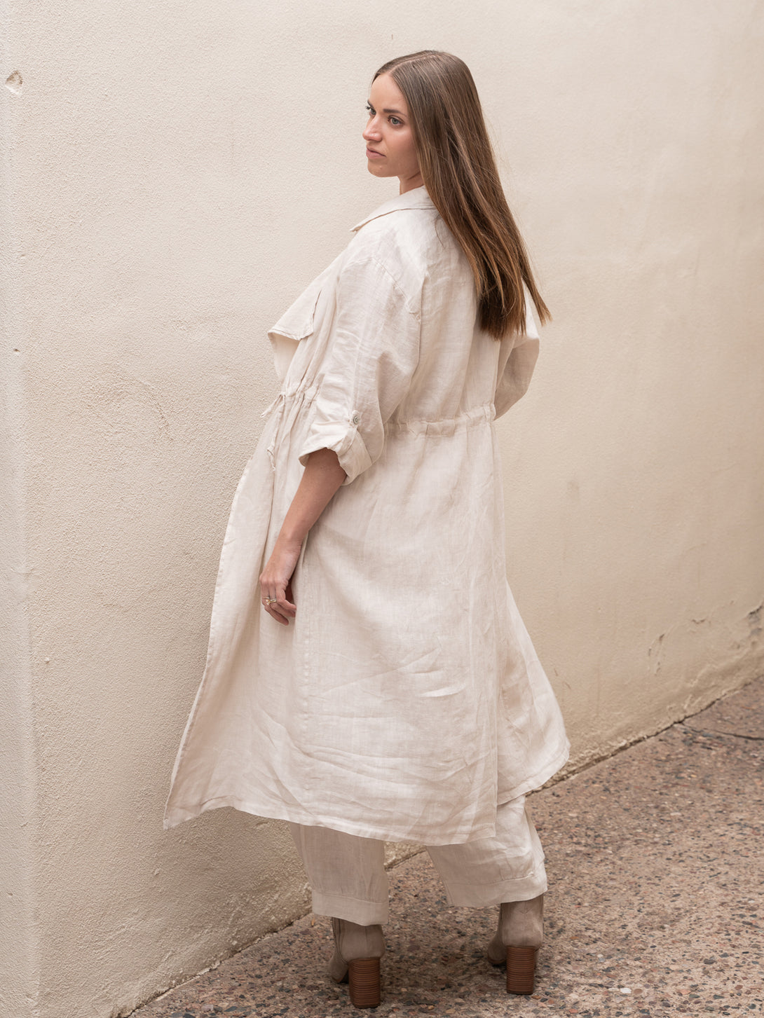 Conscious Coterie Lany Linen Cardigan in beige on model looking over shoulder full back view