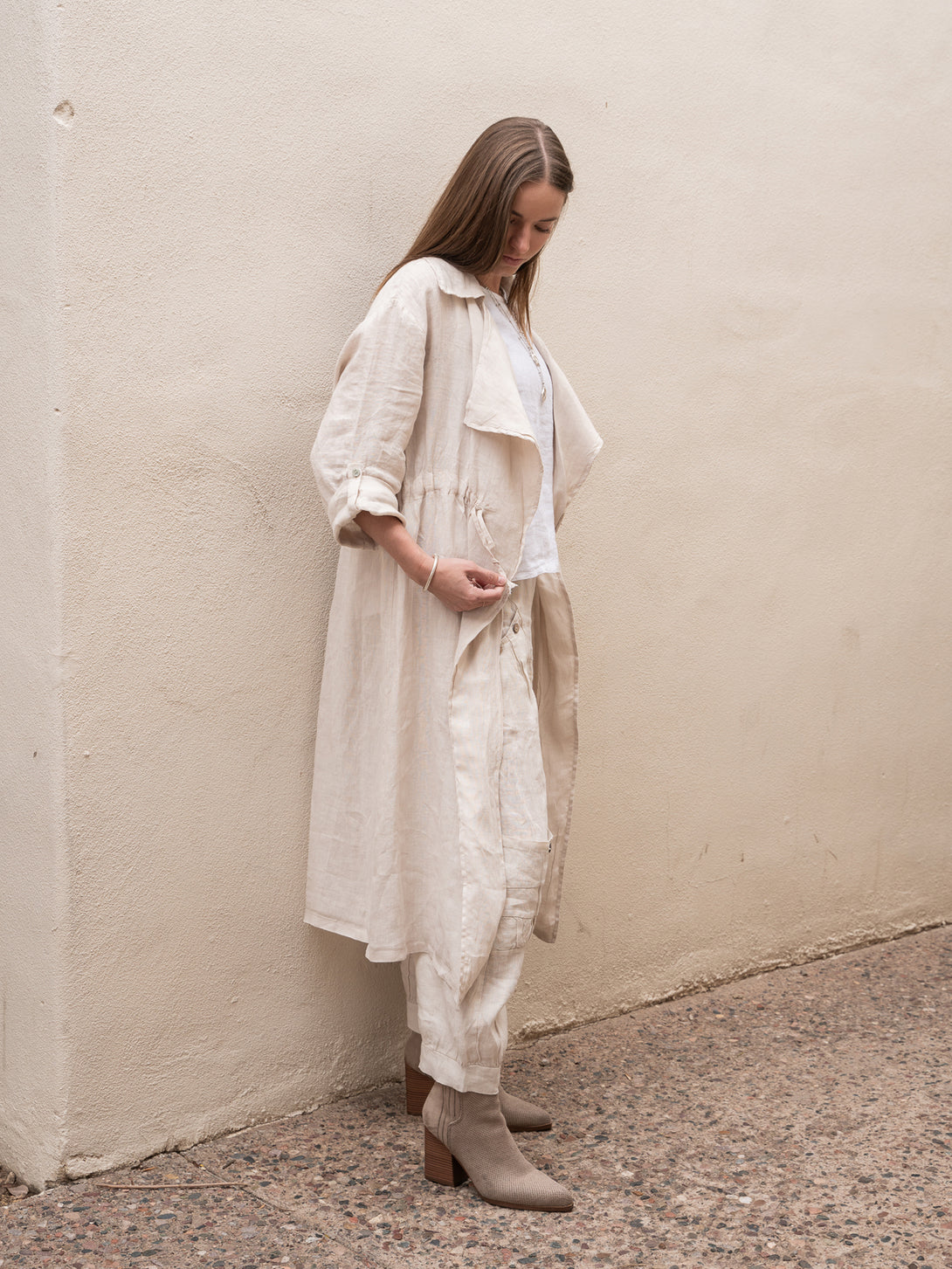 Conscious Coterie Lany Linen Cardigan in beige on model touching ties full side view