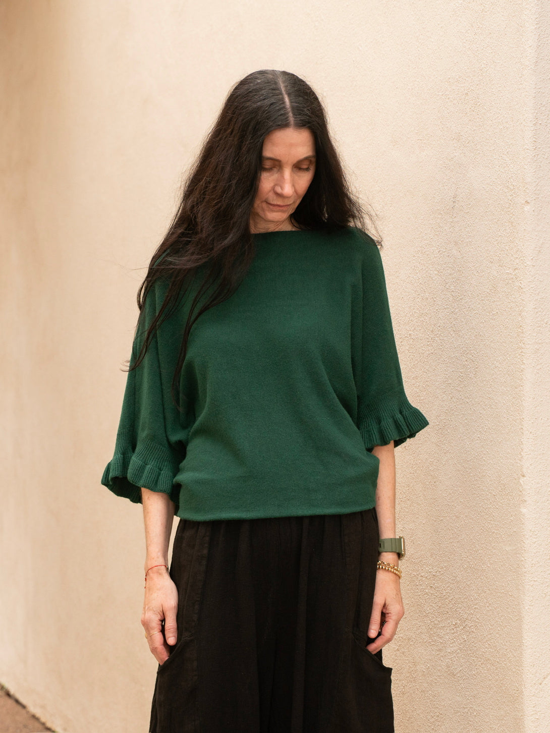 Conscious Coterie Lila Ruffle Sleeve Sweater in forest green on model looking down front view