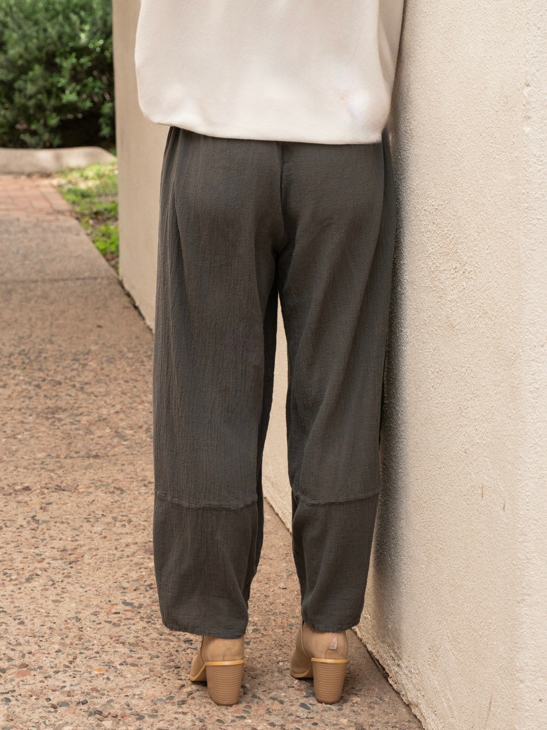 Conscious Coterie Lucy pant in charcoal grey close up back view of pants on woman