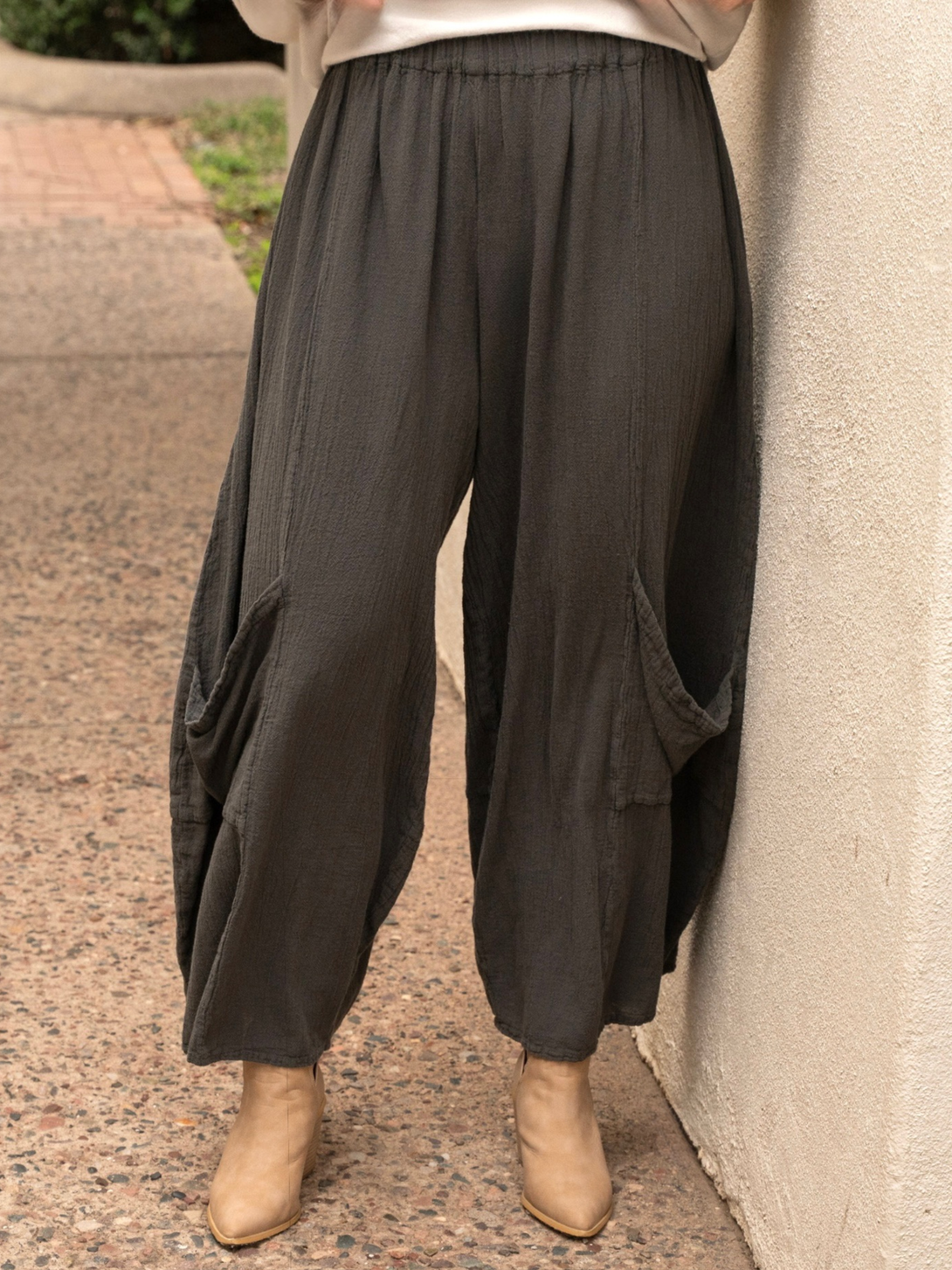 Conscious Coterie Lucy pant in charcoal grey close up front view of pants on woman