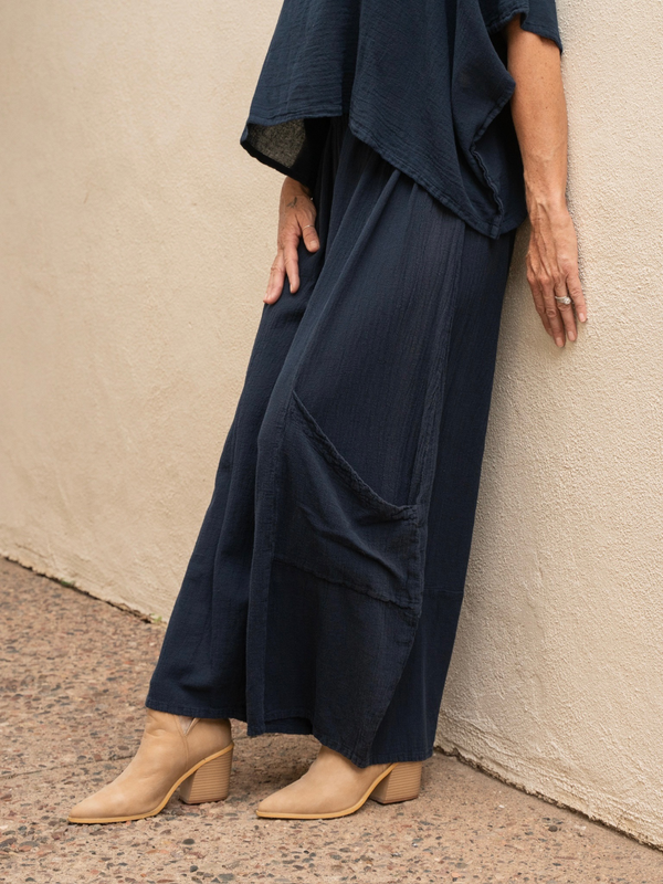 Conscious Coterie Lucy pant in navy blue close up view of side of the pant featuring the big pocket on the lower portion of the leg