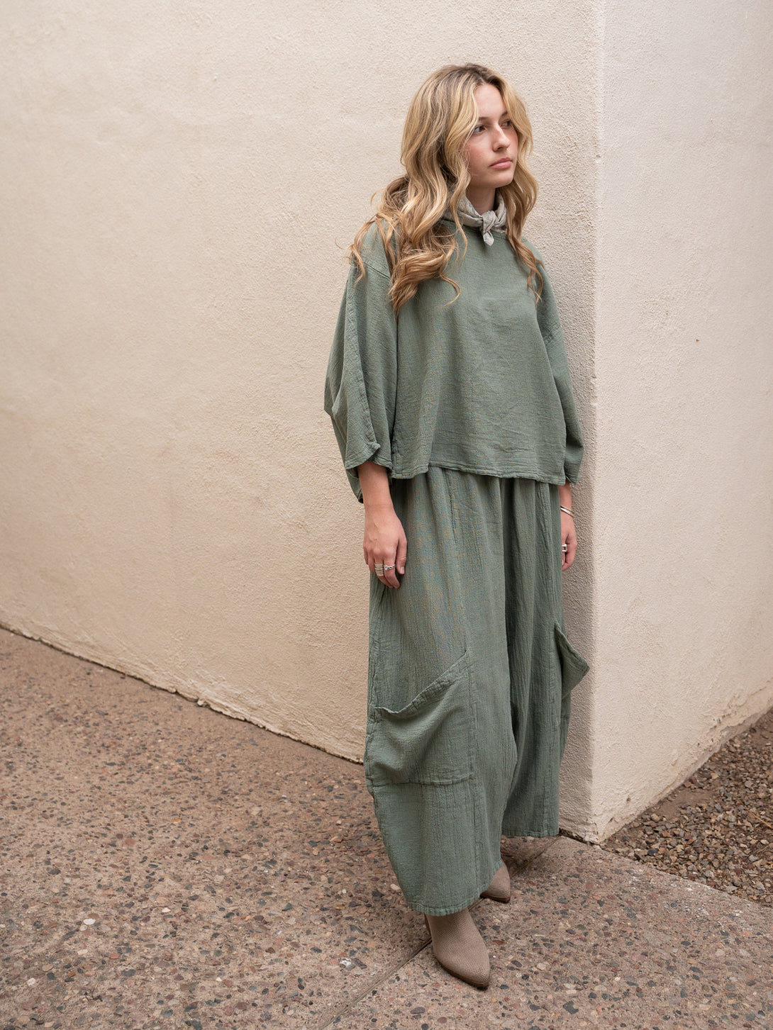 Conscious Coterie Lucy Pant in sage cotton on model gazing full front side view