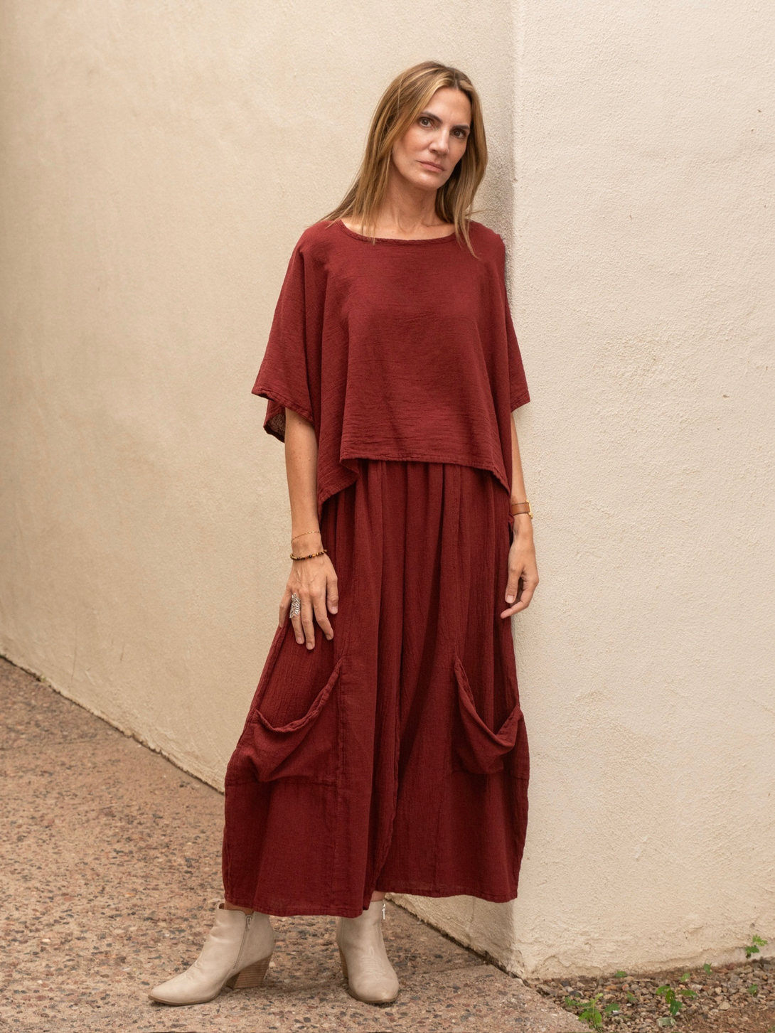 Conscious Coterie Lucy cotton pant in wine red full body photo on woman facing forward to see front of the pant with the matching top