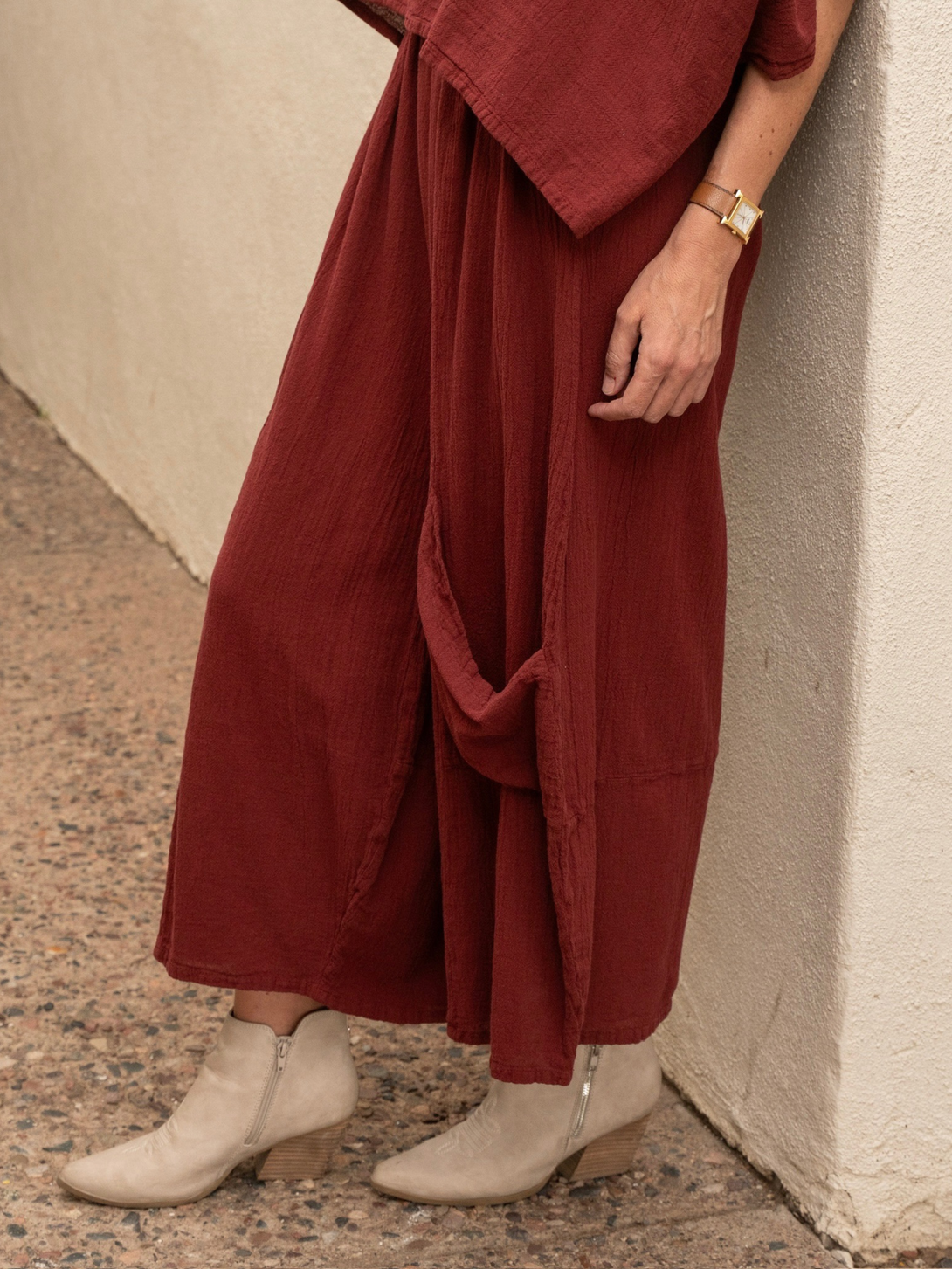 Conscious Coterie Lucy cotton pant in wine red close up side view of the pants featuring the big low hanging pocket