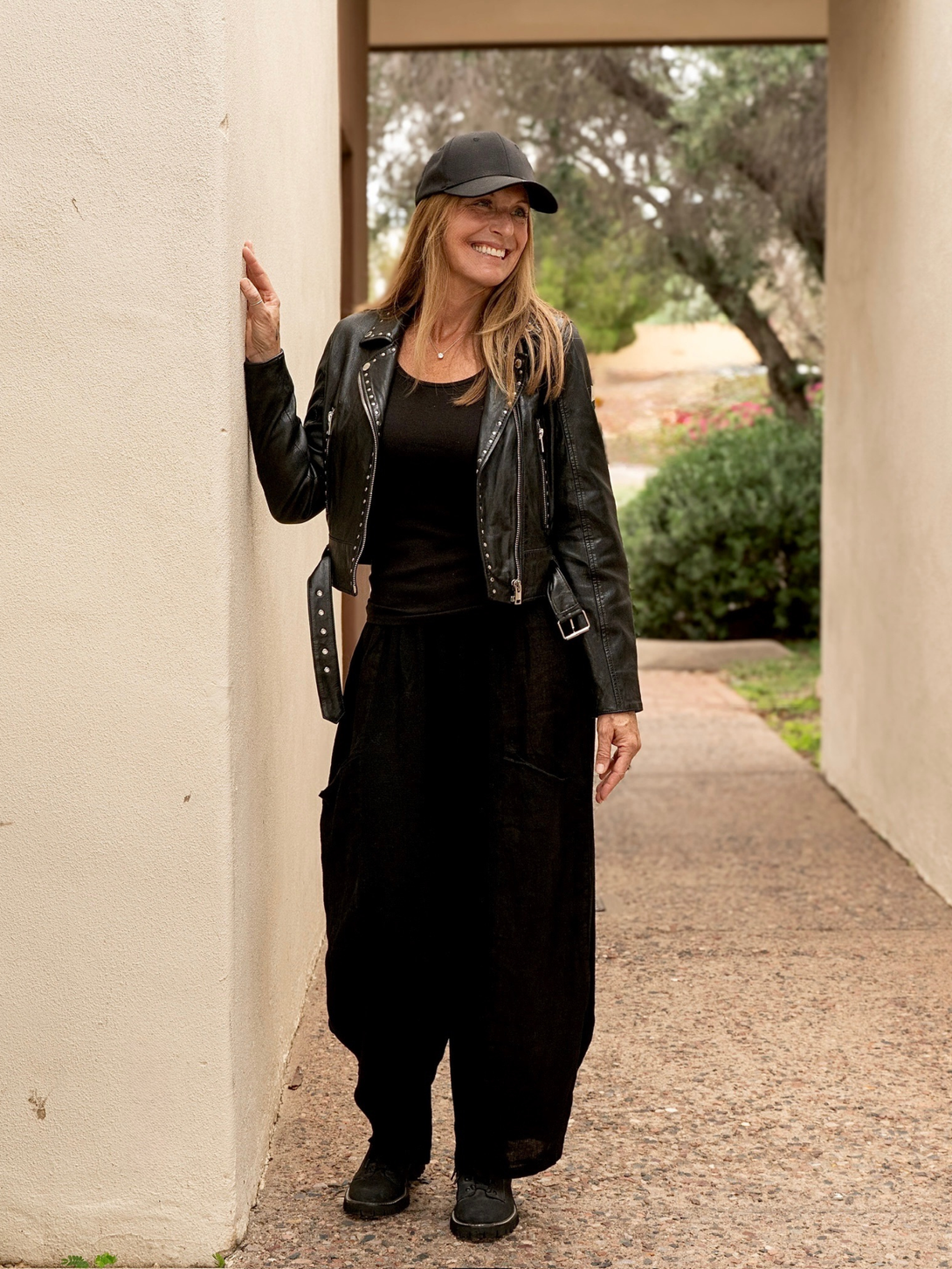 Conscious Coterie Maryn leather jacket in black full body photo of woman wearing jacket showing the front view 