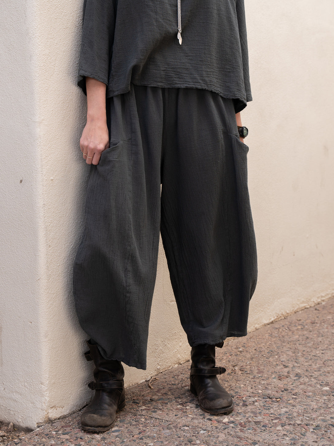 Conscious Coterie Mickey Pant in charcoal cotton on model with hand in pocket front bottom view
