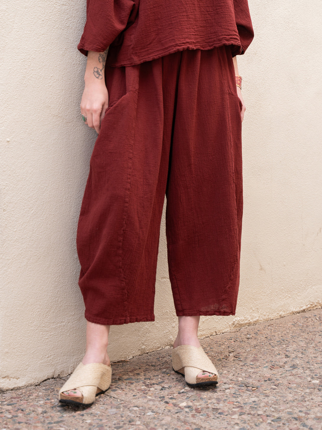 Conscious Coterie Mickey Pant in wine cotton on model front bottom view