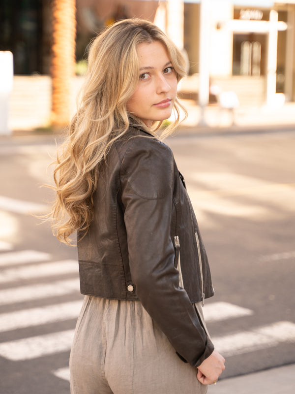 Conscious Coterie Reanon Leather Jacket in brown on model looking over shoulder editorial image