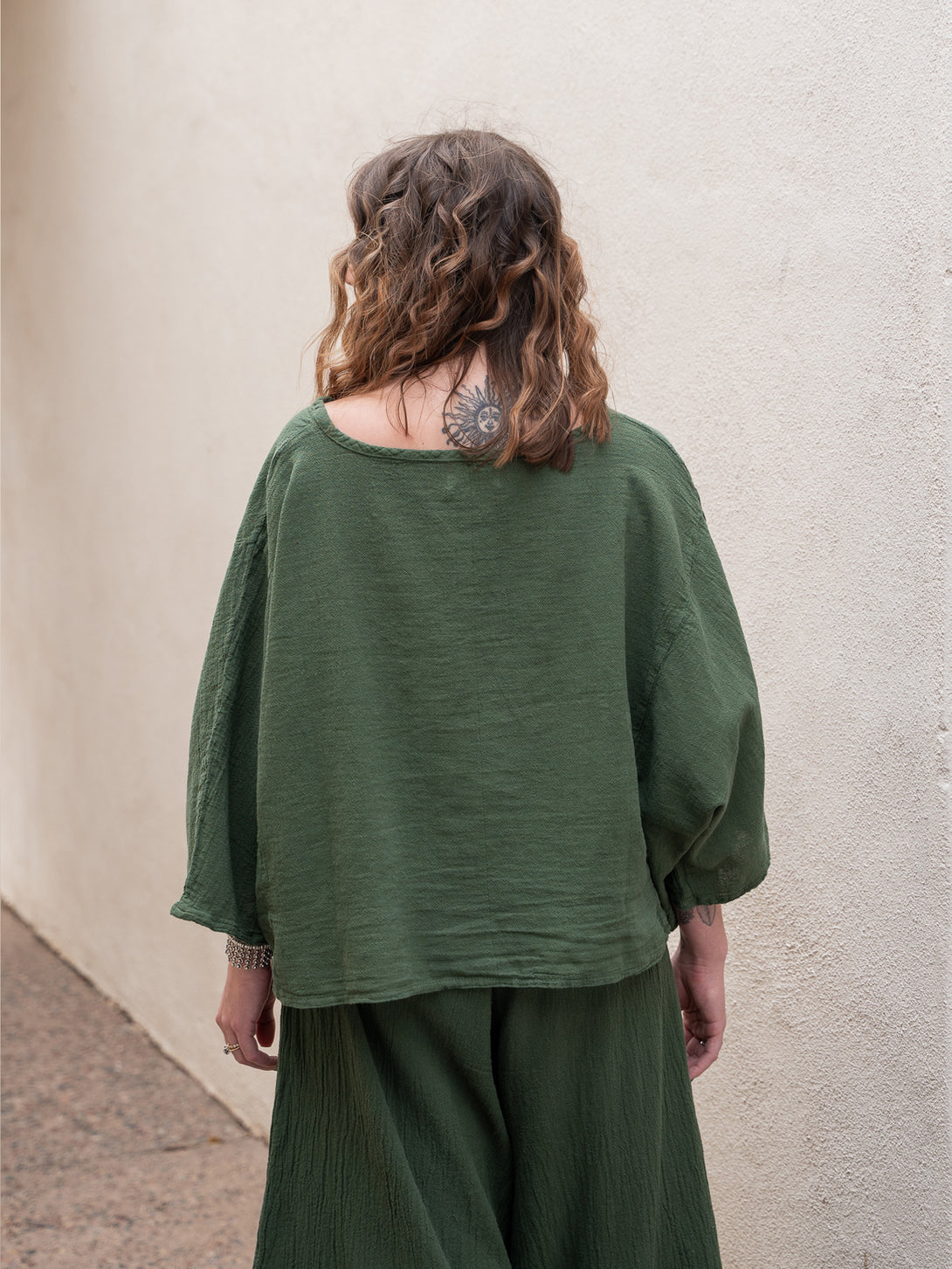Conscious Coterie Rosie Top in moss cotton on model looking left left back view