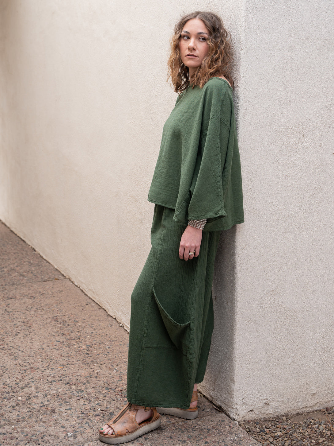 Conscious Coterie Rosie Top in moss cotton on model looking left full side view