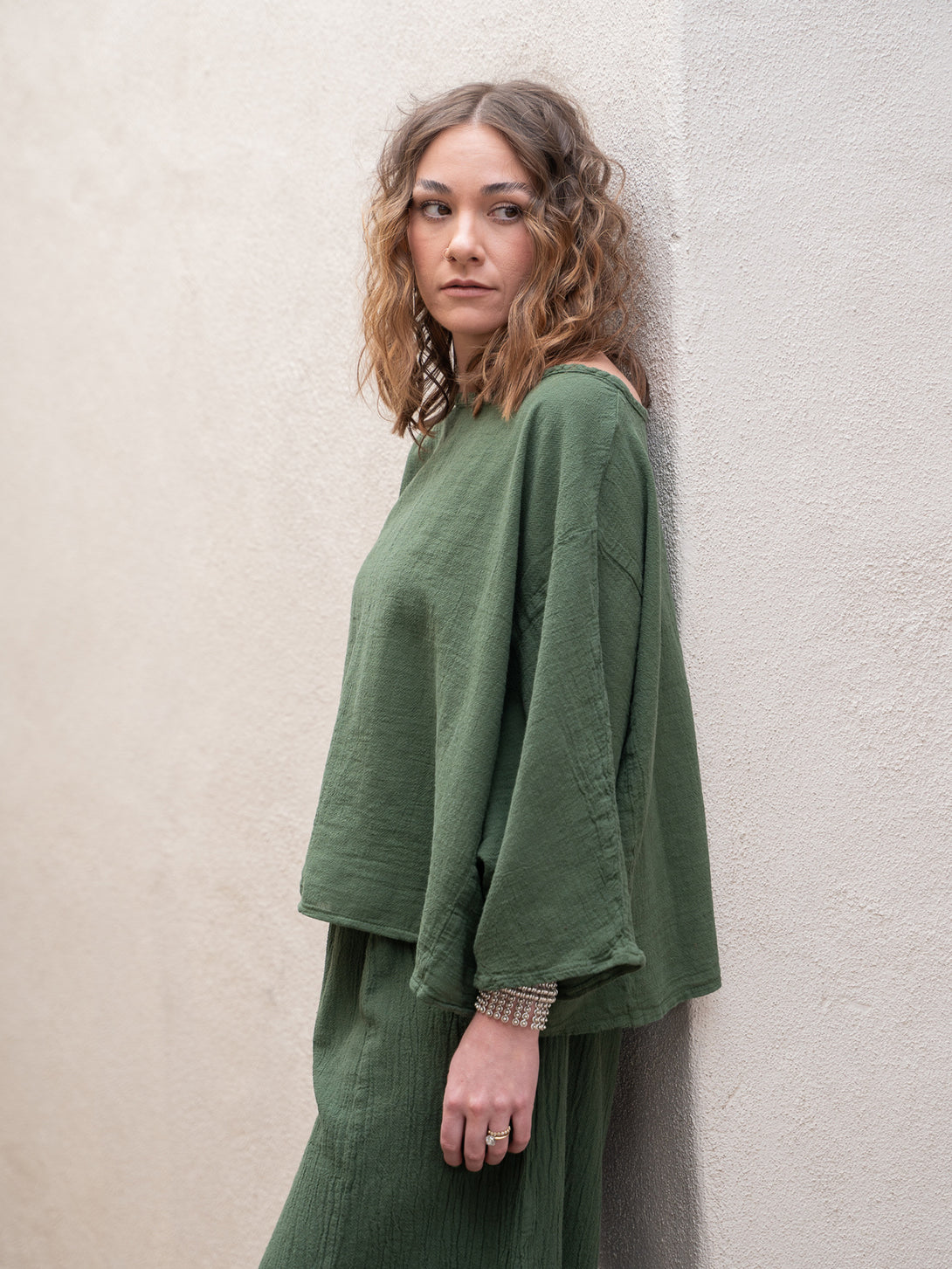 Conscious Coterie Rosie Top in moss cotton on model looking left side view