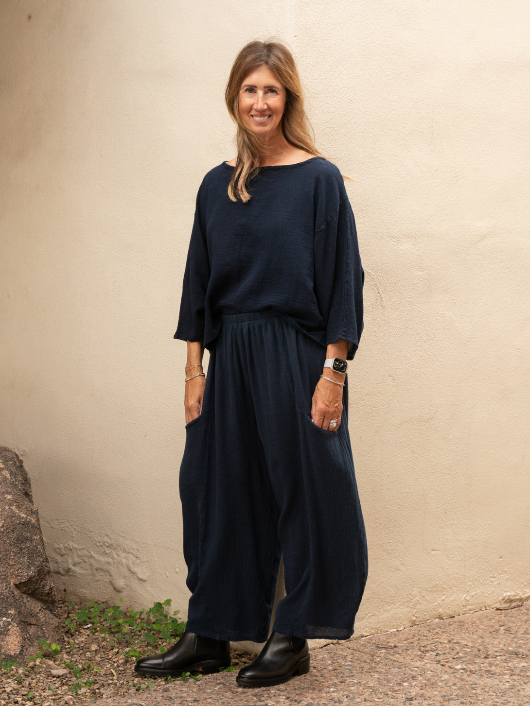 Conscious Coterie Rosie top in navy blue full body view of tip with matching bottom, facing forward and model smiling