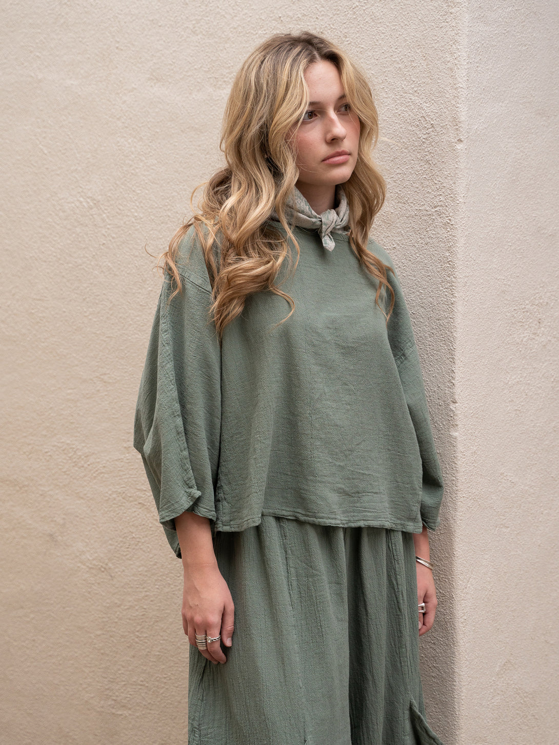 Conscious Coterie Rosie Top in sage cotton on model head tilted front view