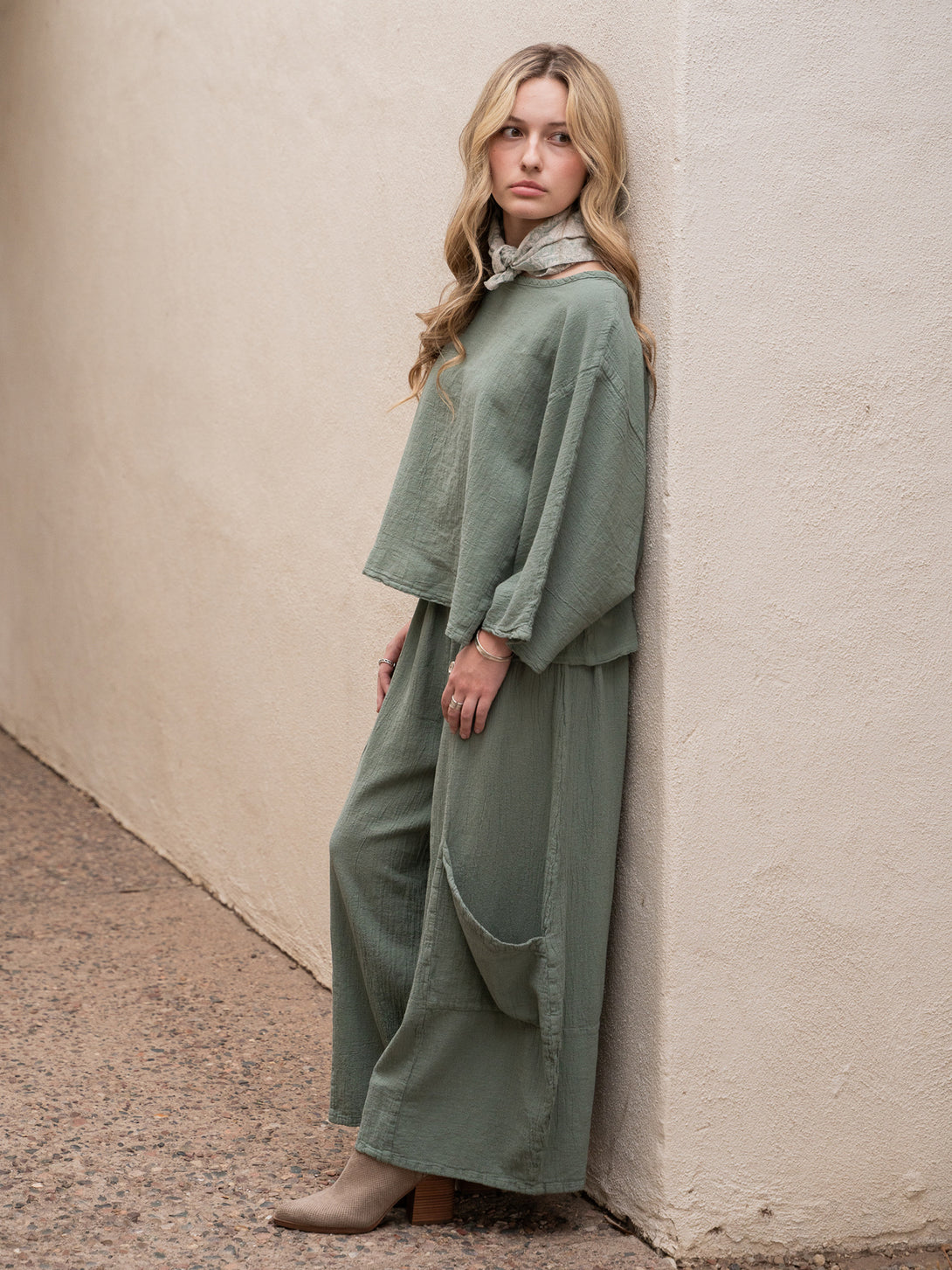 Conscious Coterie Rosie Top in sage cotton on model looking left full side view