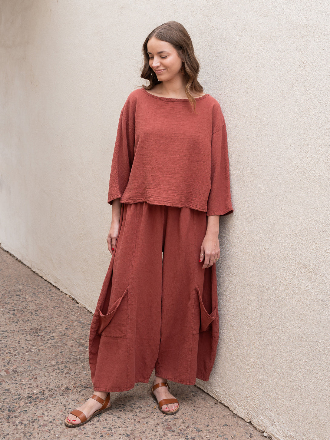 Conscious Coterie Rose Top in terracotta cotton on model looking down full front view
