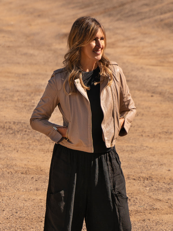 Conscious Coterie Sinta Leather Jacket in sand on model smiling editorial image