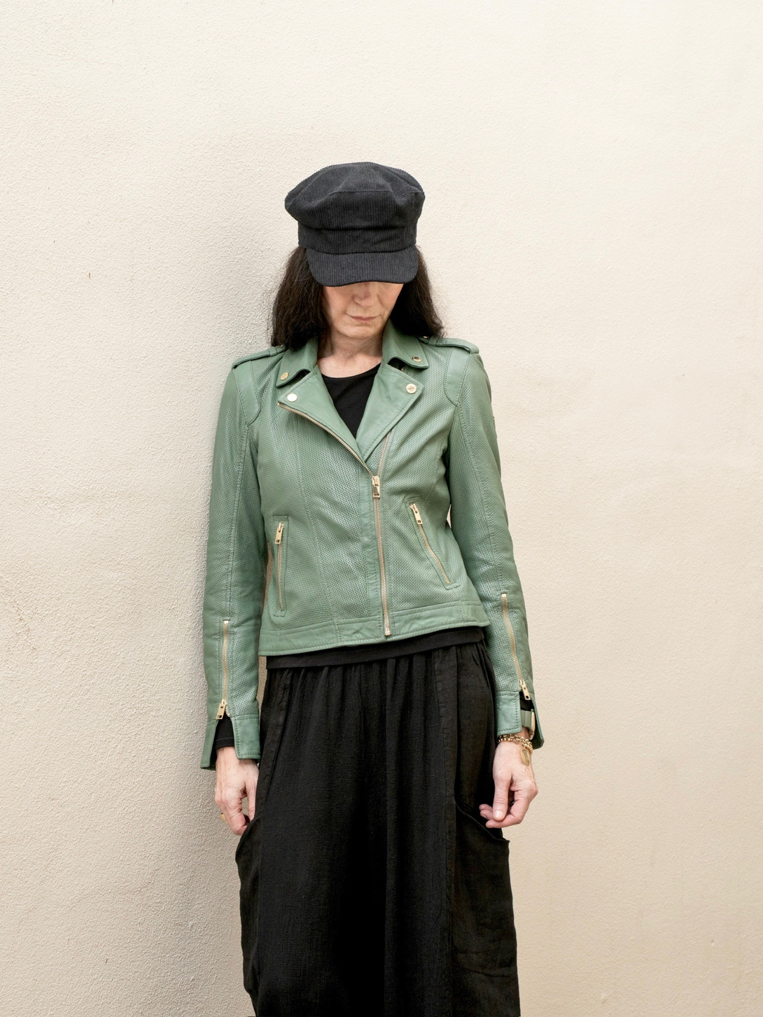 Conscious Coterie Sinta leather jacket in sage green photo of woman wearing jacket zipped up 