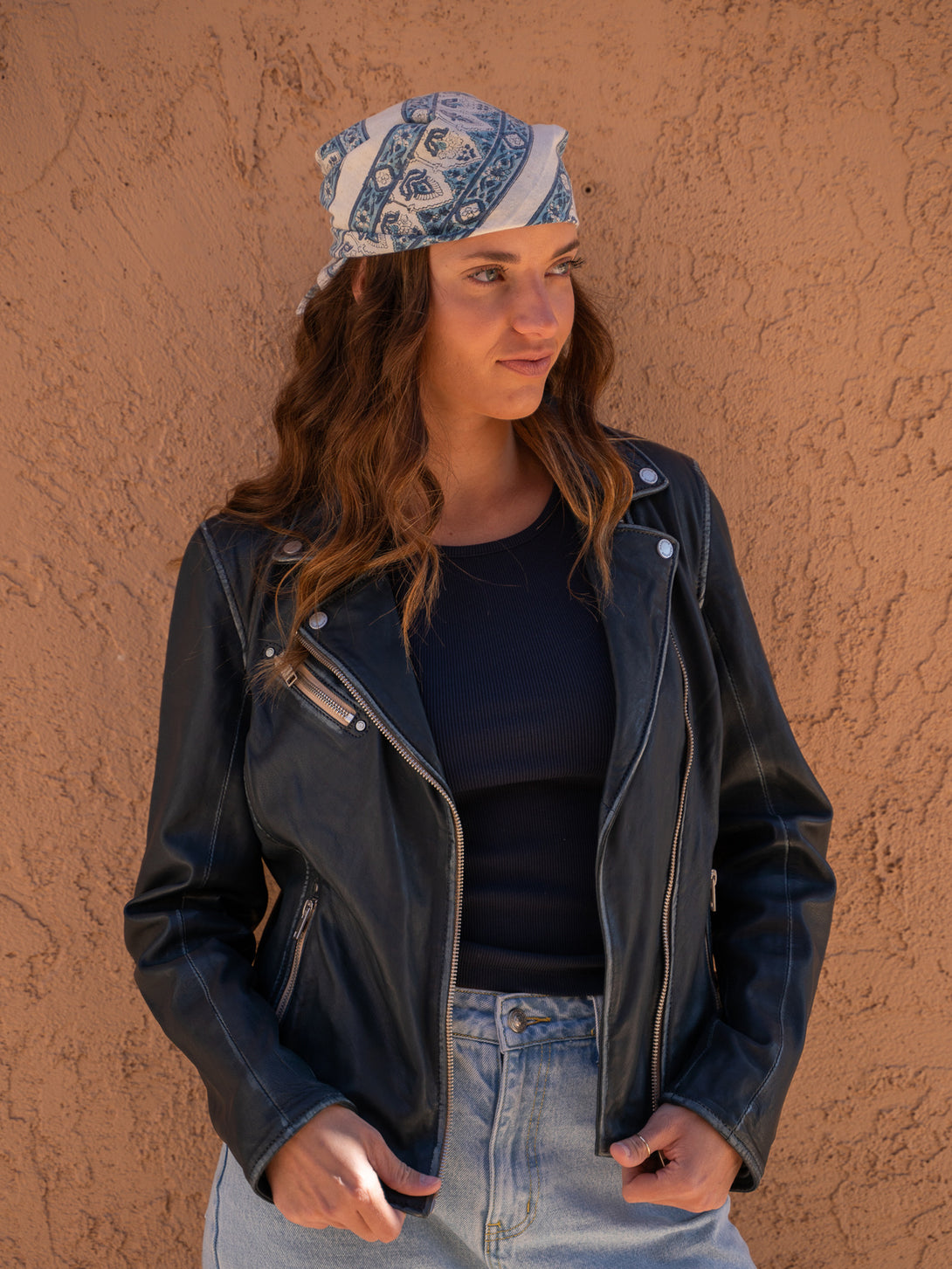 Conscious Coterie Sofia Leather Jacket in Denim Blue on model wearing a bandana with blue print