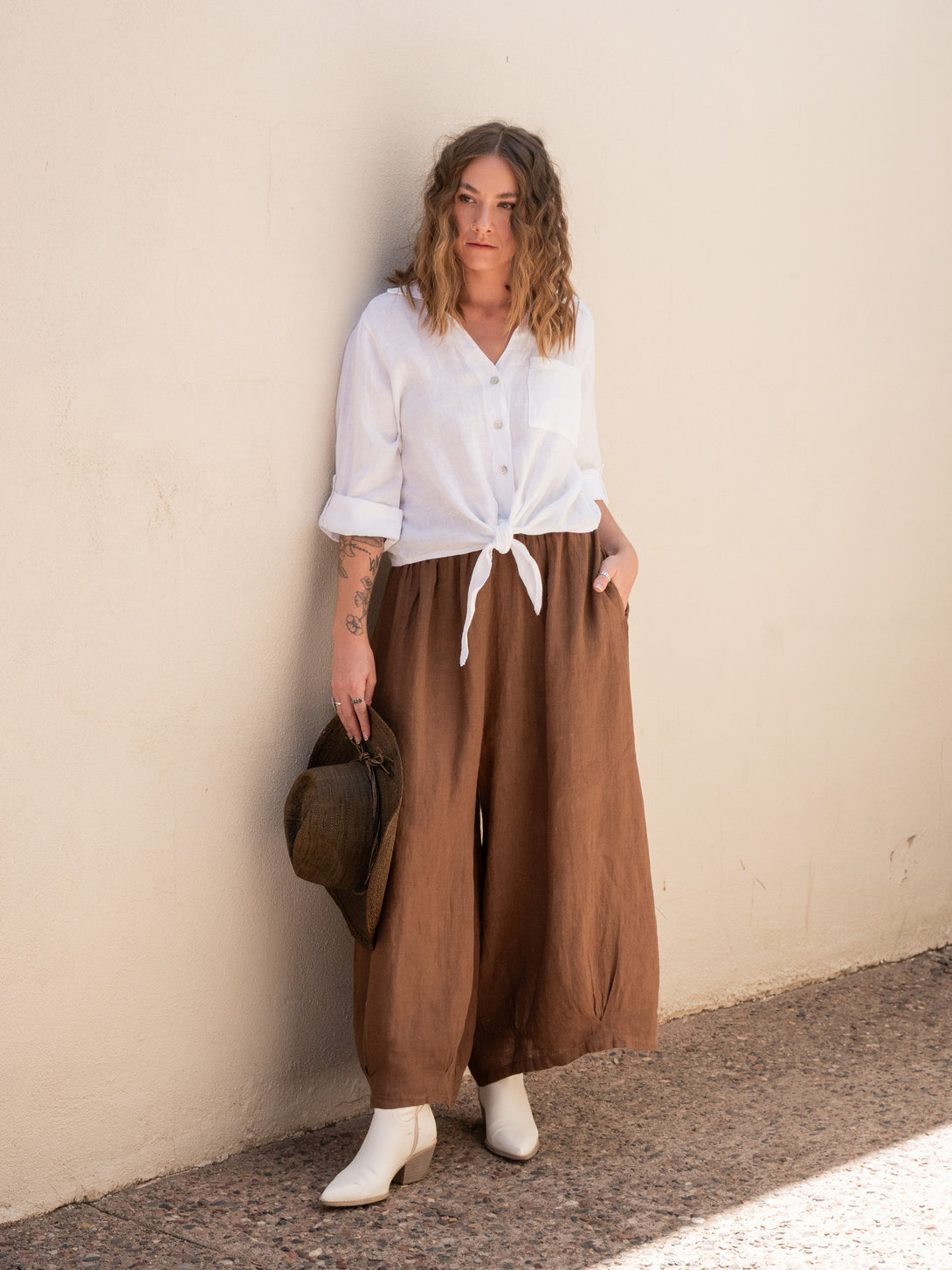 Conscious Coterie Stevie Linen Pant in Coffee on model with hand in pocket full front view
