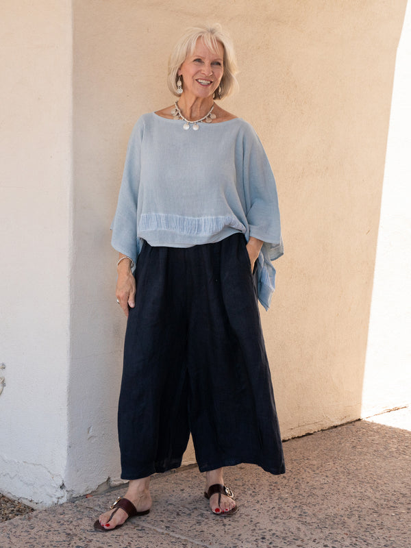 Conscious Coterie Stevie Linen pant in Navy on model smiling full front view