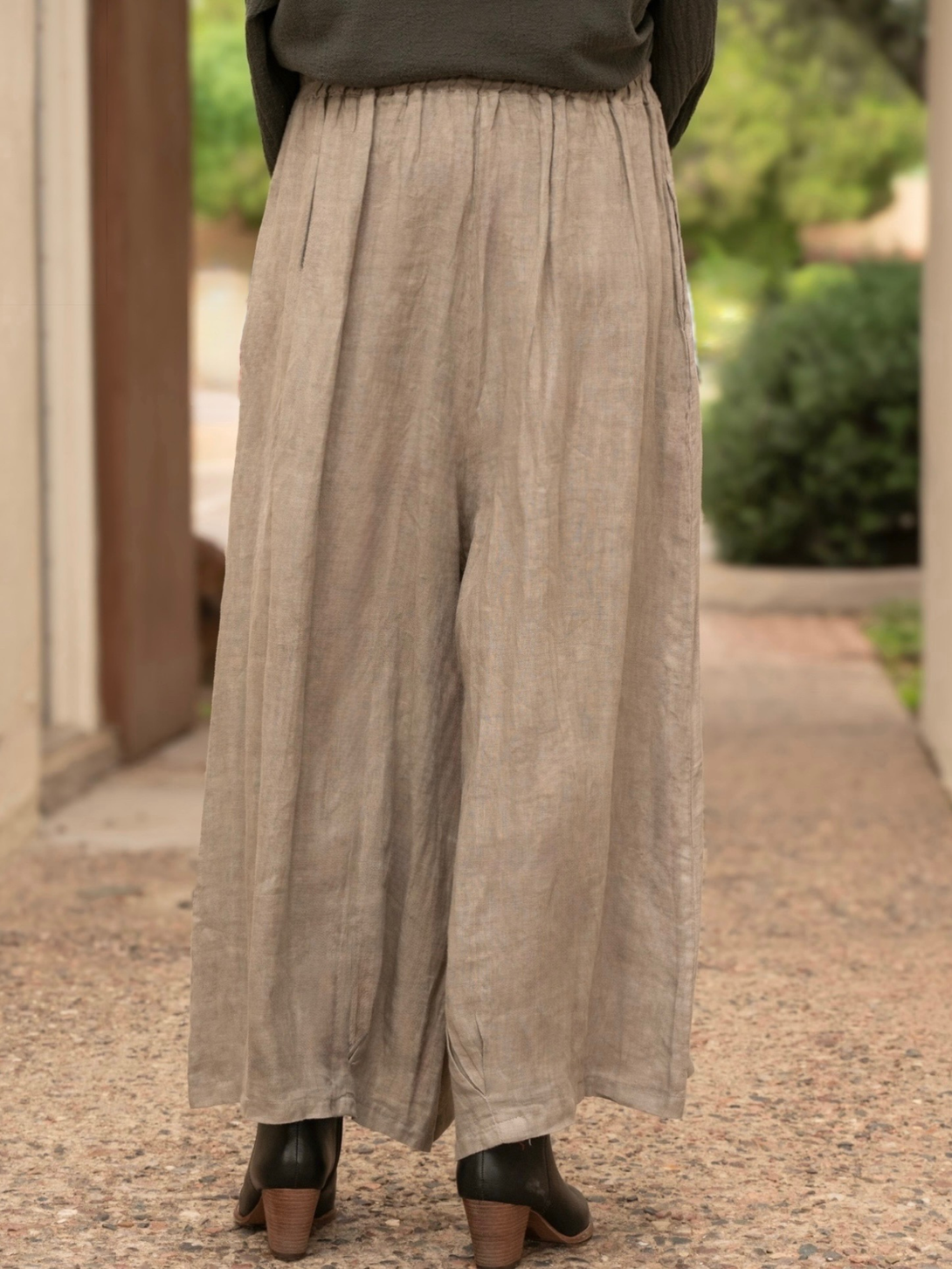 Conscious Coterie Stevie linen pant in taupe woman wearing pants facing away to see the back of the pants